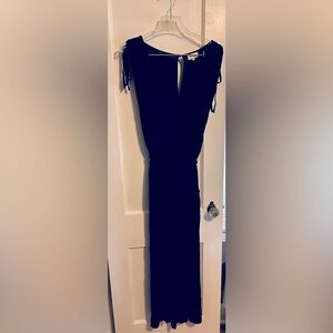 Navy blue knit jumpsuit with flowing cropped legs and tie shoulders